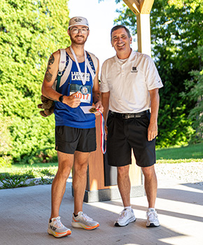 LMHS President & CEO Rob Montagnese stands with Jonathon Holbrook, top male finisher of the "For Your Health" 5K